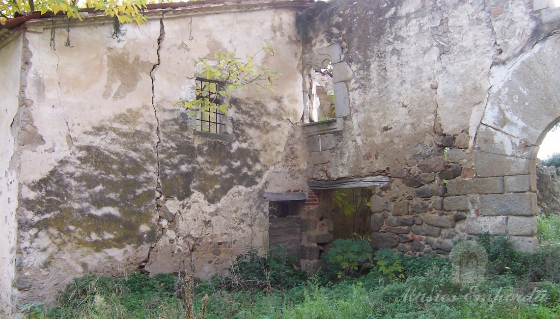 Parte del muro exterior de la casa con un arco de medio punto en un lateral de la imagen