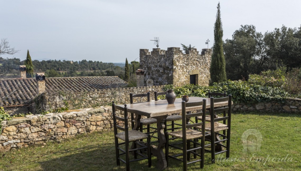Zona de piscina con vistas a la torre de la masía y los campos y bosque de la propiedad