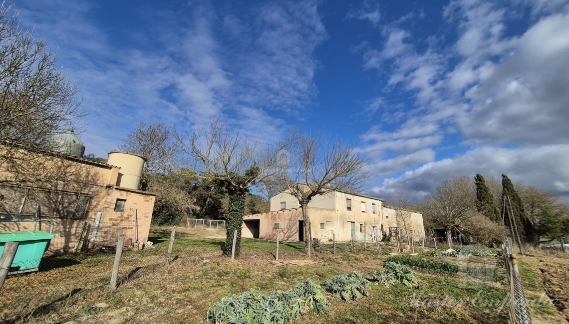 Vista del lateral de la masia i les quadres