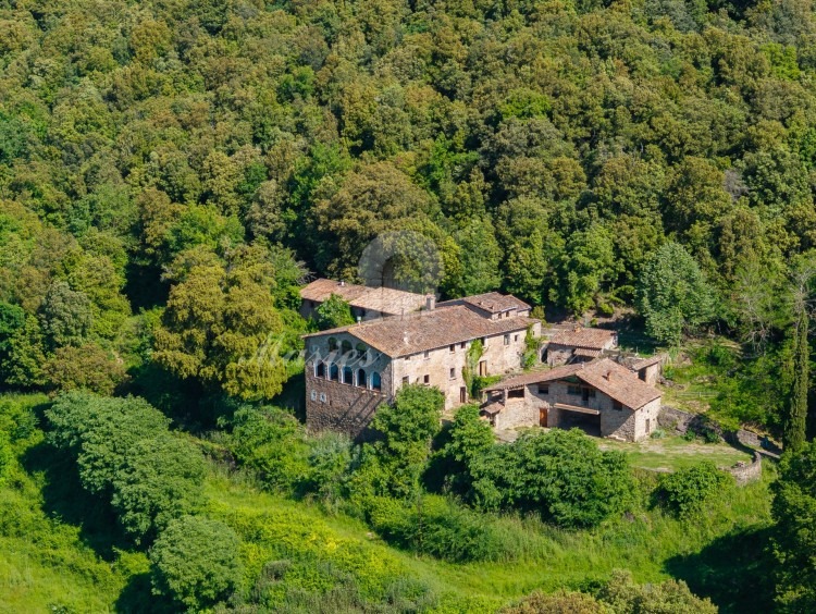 Vista general de la masia i dels camps de la propietat que l'envolten